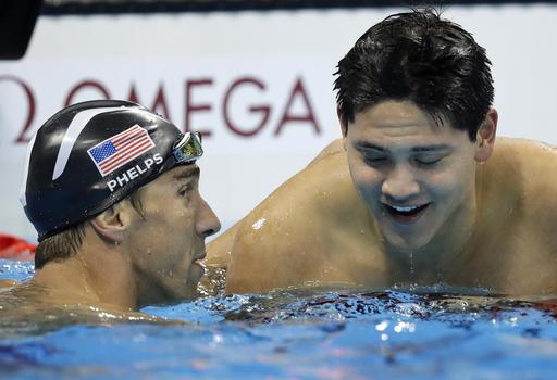 Singapore’s Joseph Schooling right is congratulated by Michael Phelps after winning the gold medal in the men’s 100-meter butterfly final on Friday night in Rio