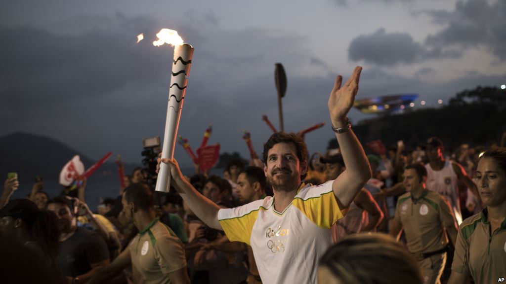 Leonardo Espindola carries the Olympic torch on its way to Rio de Janeiro for the opening ceremony of Rio's 2016 Summer Olympics in Niteroi Brazil on Aug. 2 2016