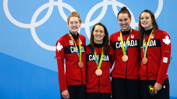 Chantal Van Landeghem and teammates Tayor Ruck, Sandrine Mainville and Penelope Oleksiak pose with their bronze medals