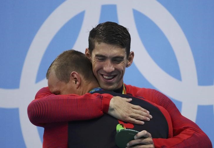 2016 Rio Olympics- Swimming- Victory Ceremony- Men's 4 x 100m Freestyle Relay Victory Ceremony- Olympic Aquatics Stadium- Rio de Janeiro Brazil- 07/08/2016. Michael Phelps of USA embraces teammate Ryan Held on the podium REUTERS  St