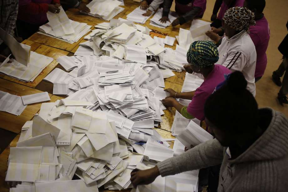 Election officials start the ballot counting process at a polling station during municipal elections in Manenberg on the outskirts of Cape Town South Africa Wednesday Aug. 3 2016. South Africans voted Wednesday in municipal elections described as the