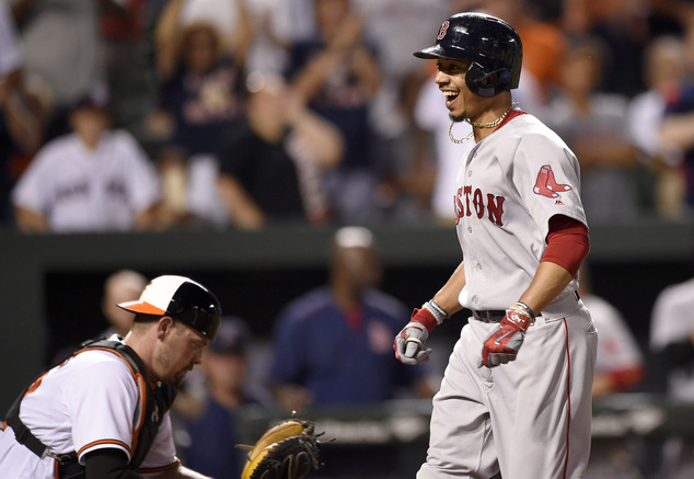 Boston Red Sox's Mookie Betts right comes home to score after he hit a two-run home run during the eighth inning of a baseball game as Baltimore Orioles