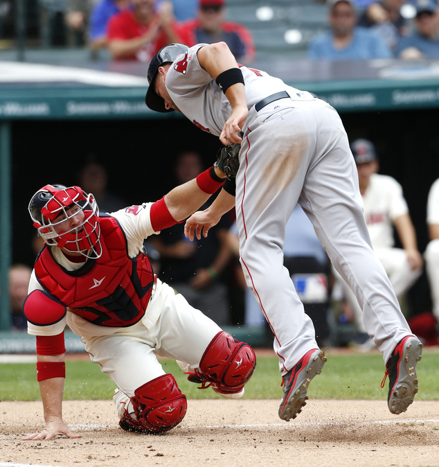 Cleveland Indians catcher Chris Gimenez tags out Boston Red Sox's Travis Shaw at home plate attempting to score on a single by Dustin Pedroia durin