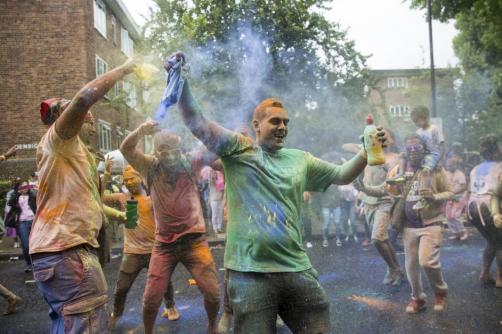 Revellers dance and throw powder paint at the Notting Hill Carnival on August 28 in London England. The Notting Hill Carnival which has taken place annually since 1964 is expected to attract over a million people