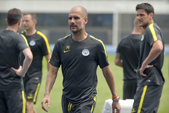 Manchester City manager Pep Guardiola center leaves the field after his team's training session at the Olympic Sports Center Stadium in Beijing China. City play Borussia Dortmund in a friendly match at Shenzhen’s Longgang Stadium on Thursday July 28