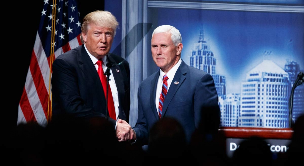 Republican presidential candidate Donald Trump shakes hands with his running mate Republican vice presidential candidate Indiana Gov. Mike Pence as he arrives to give an economic policy speech to the Detroit Economic Cl