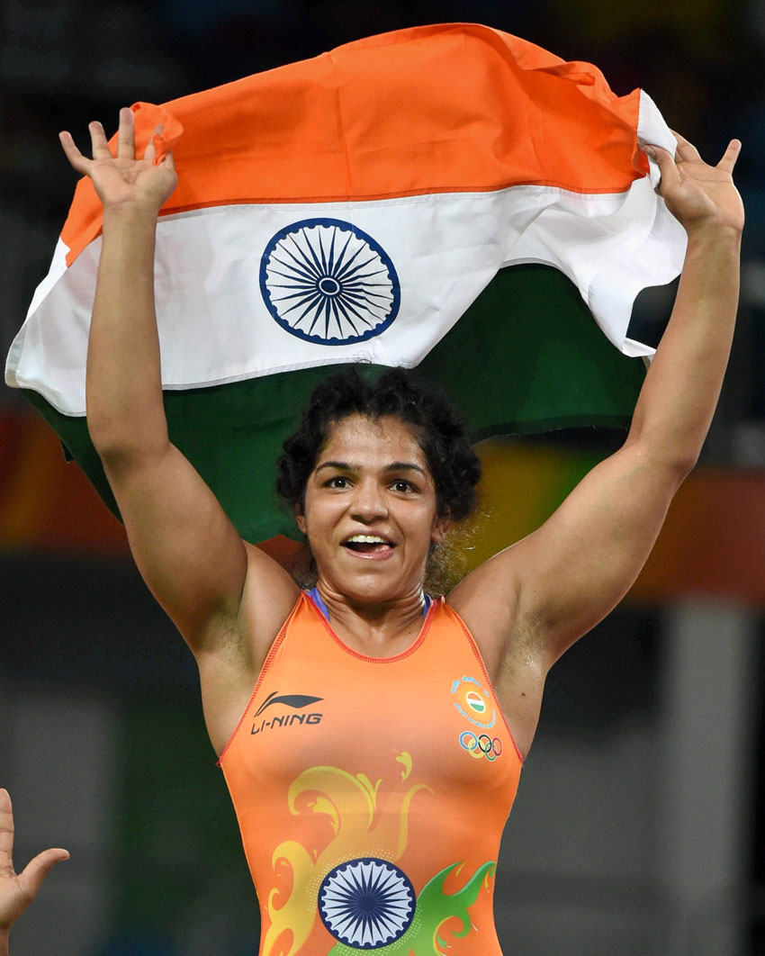 India's Sakshi Malik waves the Indian Tricolor after winning the bronze against Kyrgyzstan's Aisuluu Tynybekova in the women's wrestling freestyle 58-kg competition at the 2016 Summer Olympics in Rio de Janeiro Brazil Aug. 17