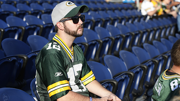 A Green Bay Packers fan sits in the stands prior to the 2016 NFL Hall of Fame Game at Tom Benson Hall of Fame Stadium in Canton Ohio. The game was cancelled due to poor field conditions