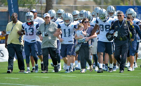 Dallas Cowboys strong safety Barry Church, cornerback Orlando Scandrick and tight end Jason Witten escort Dallas Police Chief David Brown onto the field for a statement about unity on opening day of training camp in Oxnard Calif. on Satur