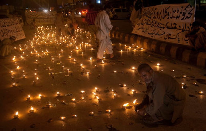 Supporters of Pakistan Muslim League-Q group light clay-lamps for the victims of Monday's suicide bombing during a vigil in Karachi Pakistan Tuesday Aug. 9 2016. Pakistani lawyers are mourning colleagues slain in a shocking suicide bombing the pre