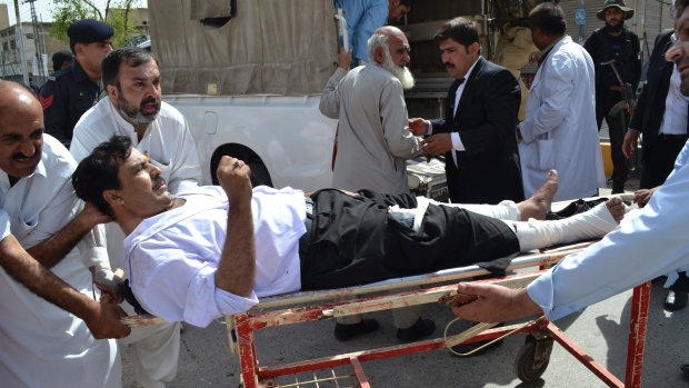 People carry an injured lawyer following a bomb blast in Quetta Pakistan on Monday. powerful bomb went off on the grounds of a government-run hospital Monday killing dozens of people police said