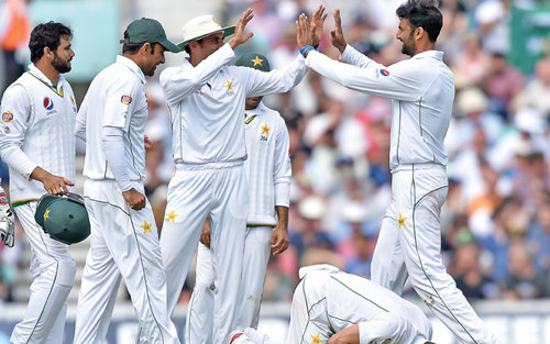 Pakistan players celebrates after dismissing an England batsman during the fourth Test in London on Sunday