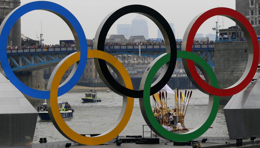 The royal barge Gloriana carries the Olympic flame along the river Thames ahead of the 2012 Summer Olympics on the final day of the Torch Relay Friday July 27