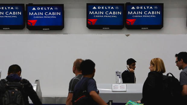 Passengers check in at a counter of Delta Air Lines in Mexico City Mexico Monday