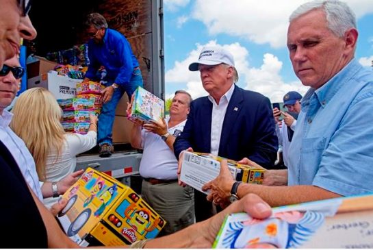 Republican presidential candidate Donald Trump and his running mate Indiana Gov. Mike Pence right help to unload supplies for flood victims during a tour of the flood damaged area in Gonzales La. Friday Aug. 19 2016