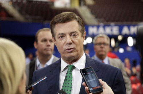 Paul Manafort talks to reporters on the floor of the Republican National Convention at Quicken Loans Arena in Cleveland