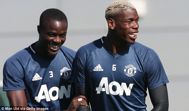 Paul Pogba shares a joke as Manchester United returned to training on Tuesday