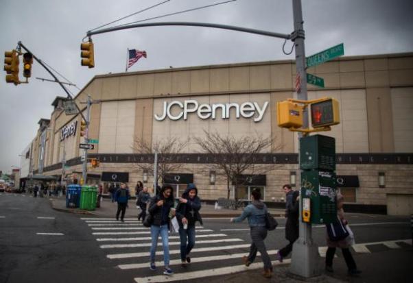 Pedestrians walk past a JC Penney store at the Queens Center Mall in New York in this