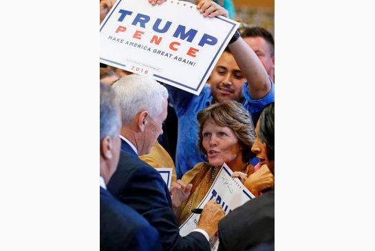 Republican vice presidential nominee Mike Pence signs an autograph after speaking at a campaign rally Tuesday Aug. 2 2016 in Phoenix