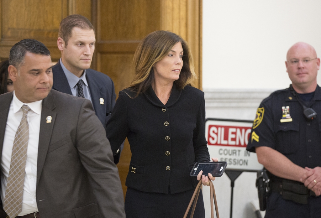 Pennsylvania Attorney General-2 Pennsylvania Attorney General Kathleen Kane escorted by members of her security team prepares to leave the Montgomery County Courthouse and await a verdict Monday afternoon. Kane said today she would resign effective Wedn