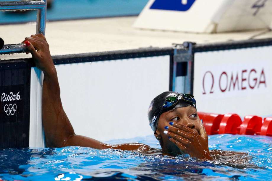 RIO DE JANEIRO BRAZIL- AUGUST 11 Simone Manuel of the United States celebrates winning gold in the Women's 100m Freestyle Final on Day 6 of the Rio 2016 Olympic Games at the Olympic Aquatics Stadium