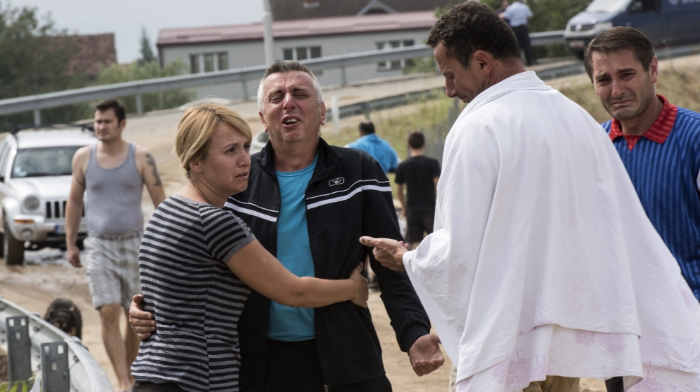 People cry after they lost a member of their family in the heavy storm that hit the country near the village of Stajkovci Skopje