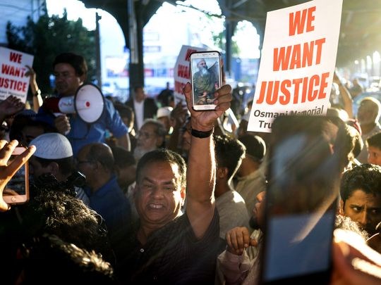 People gather for a demonstration Aug. 13 after two men were shot leaving a New York City mosque