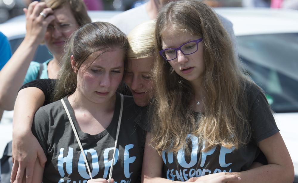 People mourn outside the Olympia shopping centre in Munich