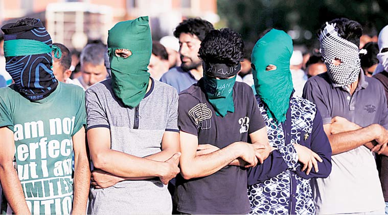 People offer funeral prayers for civilians killed in the violence in Srinagar Sunday