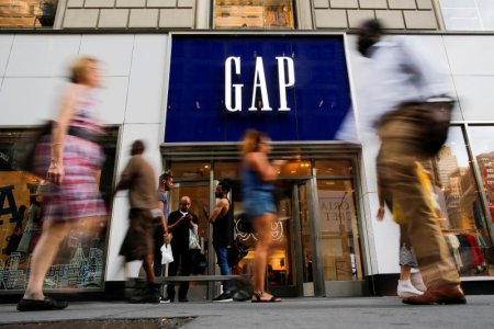 People pass by the GAP clothing retail store in Manhattan New York U.S