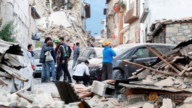 People stand along a road following a quake in Amatrice central Italy.
   
 

  Enlarge  Caption