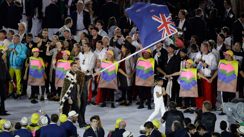 Peter Burling carries the flag of New Zealand during the opening ceremony for the 2016 Summer Olympics in Rio de Janeiro