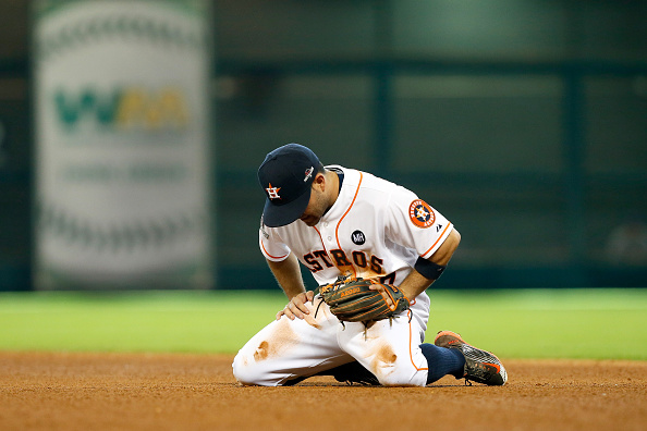 HOUSTON TX- OCTOBER 12 Jose Altuve #27 of the Houston Astros reacts after throwing to first for an out as the go-ahead run for the Kansas City Royals scores in the eighth inning during game four of the American League Divison Series at Minute Maid Par