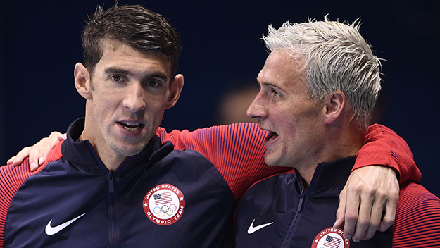 Michael Phelps and Ryan Lochte celebrate on the podium after winning the Men's 4x200 Meter Freestyle Relay Final during the swimming event at the Rio 2016 Olympic Games at the Olympic Aquatics Stadium in Rio de Janeiro