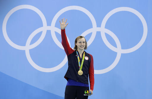 United States&#039 gold medal winner Katie Ledecky celebrates during the medal ceremony after setting a new world record in the women's 400-meter freestyle final during the swimming competitions at the 2016 Summer Olympics Monday Aug. 8 2016