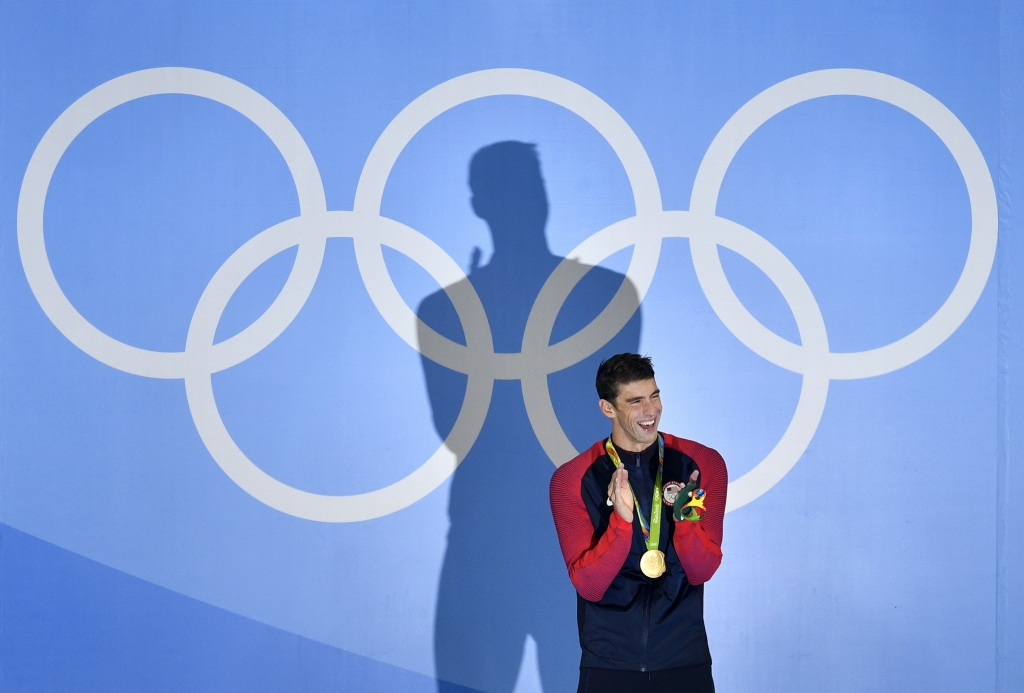 United States Michael Phelps laughs after he was awarded the gold medal during the medal ceremony for the men's 200-meter butterfly final during the swimming competitions at the 2016 Summer Olympics Tuesday Aug. 9 2016 in Rio de Janeiro Brazil. (AP