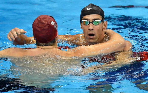 Michael Phelps from the United States is congratulated