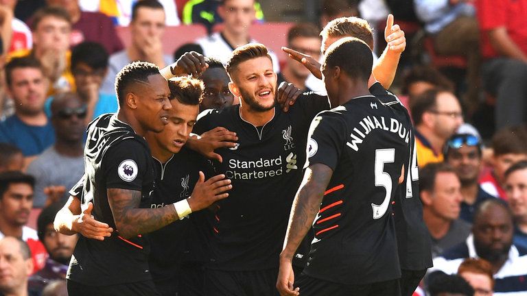 Philippe Coutinho celebrates with his team-mates after scoring Liverpool's third goal