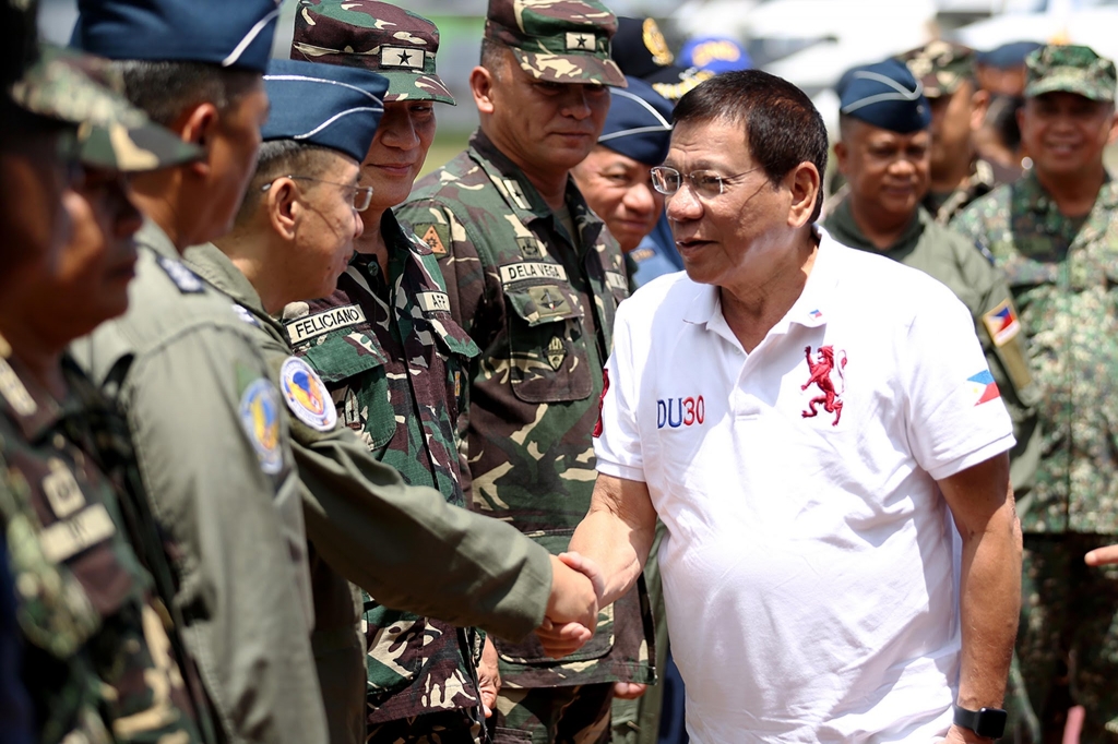 President Rodrigo R. Duterte who recently declared unilateral ceasefire with the communist rebels is welcomed by officers of the Western Mindanao Command during his arrival at Edwin Andrews Airbase in Zamboanga City on July 21