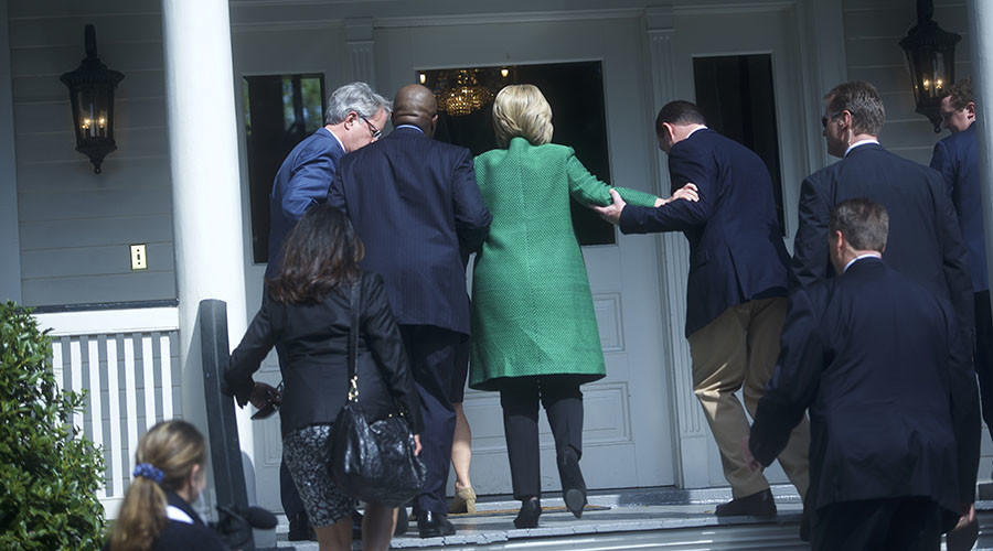 Democratic Presidential candidate Hillary Clinton slips as she walks up the stairs into the non-profit SC Strong a 2 year residential facility that helps former felons substance abusers and homeless move into self-sufficiency