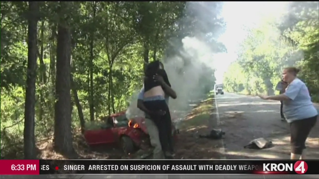 TV photographer rescues woman from burning car