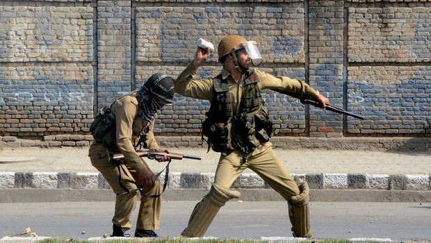 A policeman throws a teargas shell towards protesters to disperse them during clashes in Srinagar on Wednesday | PTI