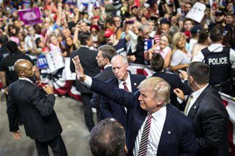 Republican presidential candidate Donald Trump waves to supporters during a rally in Kissimmee Fla. AP