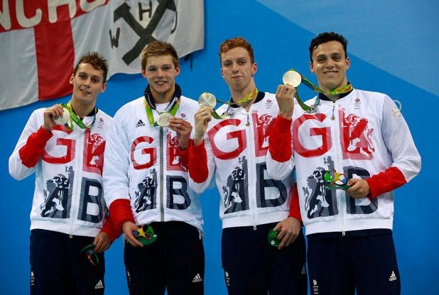 Silver medalists Daniel Wallace James Guy Stephen Milne and Duncan Scott of Great Britain pose on the podium