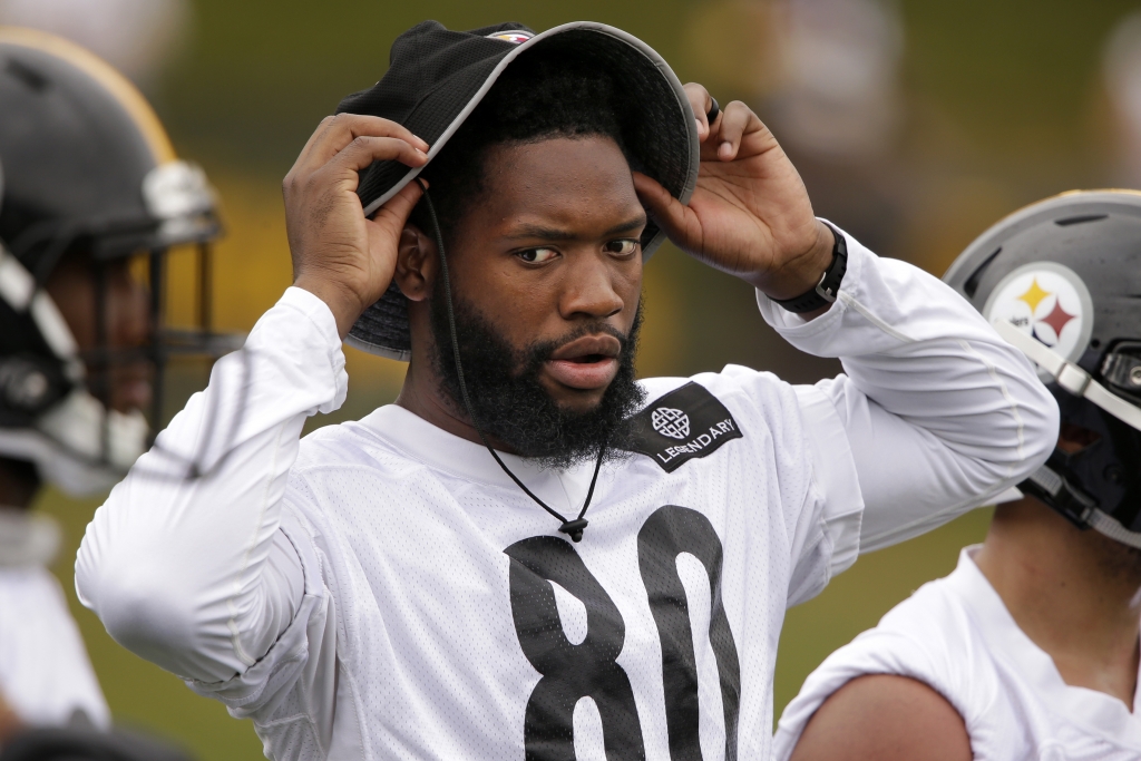 Pittsburgh Steelers tight end Ladarius Green pulls on a hat during a practice at the NFL football team's training camp in Latrobe Pa. on Saturday