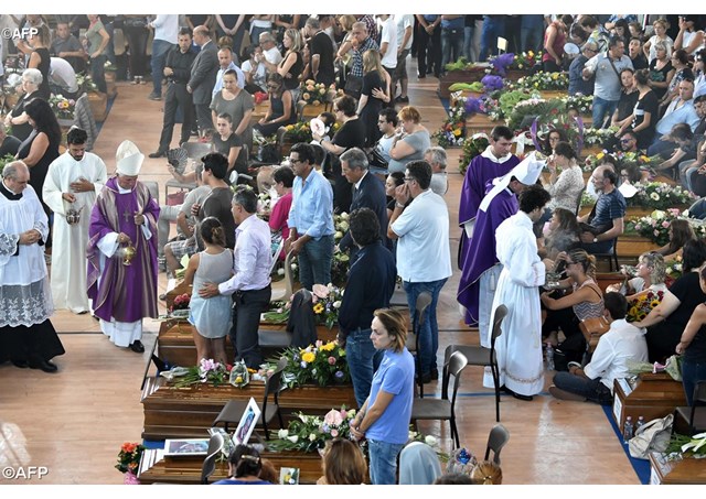 Bishop Giovanni D'Ercole incenses the caskets of some of the victims of the earthquake that struck central Italy on Wednesday. The Bishop offered a Requiem Mass for all victims of the earthquake as Italy observed a national day of mourning.- AFP