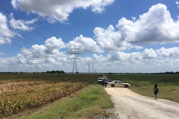 Police cars block access to the site where a hot air balloon crashed early