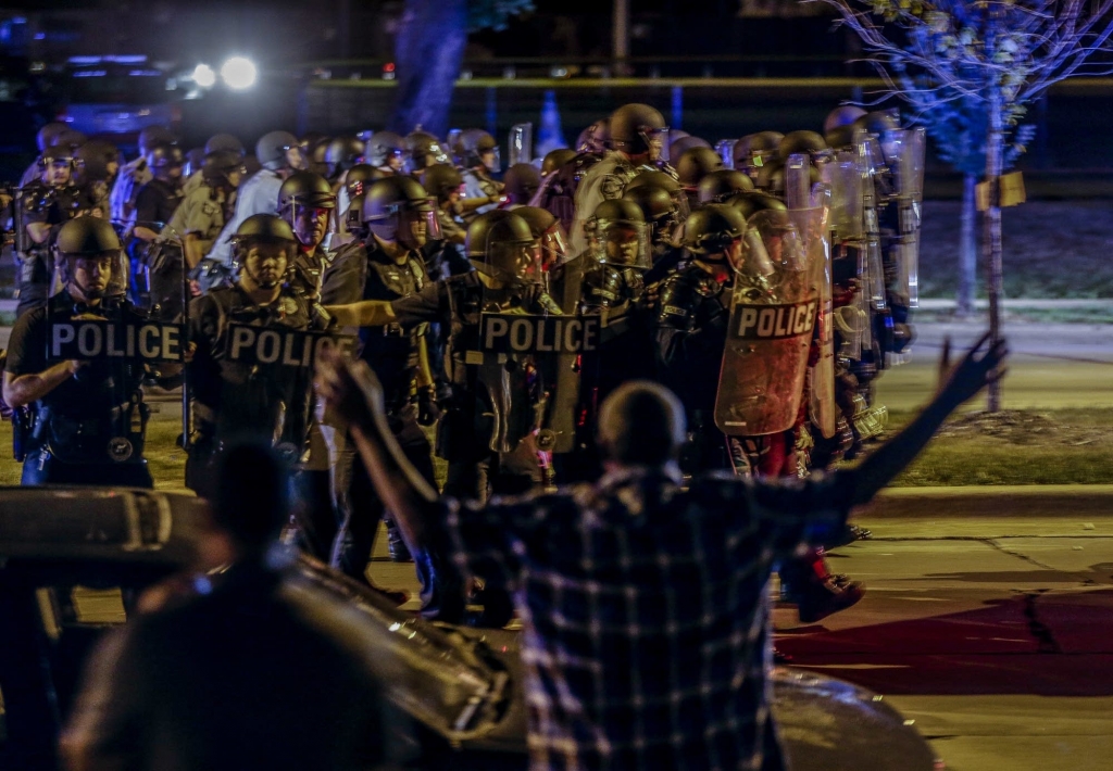 Police move in on a group of protesters throwing rocks at them in Milwaukee Sunday Aug. 14 2016