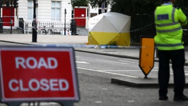 Police officer stands near a forensics tent after a knife attack in Russell Square in London