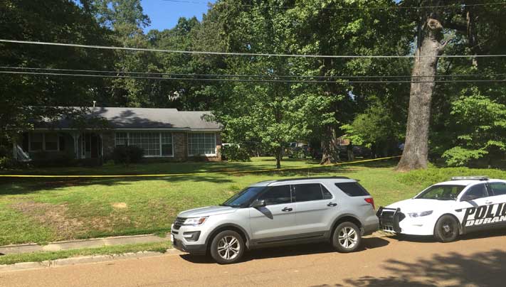 Police outside the Durant MS home where the murders occurred